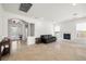 Bright living room features neutral paint, fireplace, tile flooring, and view to the entry way at 5067 Pensier St, Las Vegas, NV 89135
