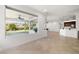 Spacious living room with natural light showcasing backyard and covered patio with ceiling fans at 5067 Pensier St, Las Vegas, NV 89135