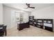 Bright office featuring custom bookshelves, neutral tile floor, and a large bay window with plantation shutters at 5067 Pensier St, Las Vegas, NV 89135