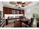 Well-lit office featuring custom built-ins, a large desk, and plantation shutters for a professional and comfortable workspace at 5067 Pensier St, Las Vegas, NV 89135
