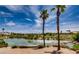 Picturesque pond with clear water and palm trees, offering a serene view of the surrounding golf course community at 5067 Pensier St, Las Vegas, NV 89135