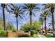 Beautifully landscaped entrance to the Village Center with a welcoming sign and lush green surroundings at 5067 Pensier St, Las Vegas, NV 89135