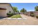 View of backyard with concrete pavers, small lawn and desert landscaping for low maintenance at 5213 Giallo Vista Ct, North Las Vegas, NV 89031