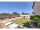 View of backyard with concrete pavers, small lawn and desert landscaping for low maintenance at 5213 Giallo Vista Ct, North Las Vegas, NV 89031