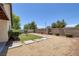 View of backyard with concrete pavers, small lawn and desert landscaping for low maintenance at 5213 Giallo Vista Ct, North Las Vegas, NV 89031