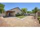 View of backyard with concrete pavers, small lawn, and covered patio at 5213 Giallo Vista Ct, North Las Vegas, NV 89031