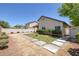 View of backyard with concrete pavers, small lawn and desert landscaping for low maintenance at 5213 Giallo Vista Ct, North Las Vegas, NV 89031