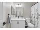 Bright bathroom with a vanity, white countertop, and framed mirror, adjacent to a shower and toilet at 5213 Giallo Vista Ct, North Las Vegas, NV 89031