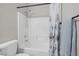 Bathroom featuring a white shower-tub combination with light gray tiling and hardware at 5213 Giallo Vista Ct, North Las Vegas, NV 89031