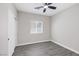 Neutral bedroom featuring a window, gray wood-look flooring, and a closet with sliding doors at 5213 Giallo Vista Ct, North Las Vegas, NV 89031