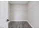 Spacious walk-in closet with white wire shelving and modern gray wood-look flooring at 5213 Giallo Vista Ct, North Las Vegas, NV 89031