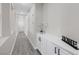 Bright hallway with wood-look floors, storage cabinets, and neutral paint for a serene ambiance at 5213 Giallo Vista Ct, North Las Vegas, NV 89031