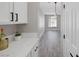 Hallway view from kitchen showcasing quartz countertops and white cabinets at 5213 Giallo Vista Ct, North Las Vegas, NV 89031