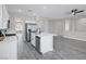 Open kitchen with island, stainless steel appliances, white cabinets and view to the living room at 5213 Giallo Vista Ct, North Las Vegas, NV 89031
