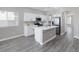 Beautiful kitchen with white cabinets, stainless steel appliances, quartz countertops and breakfast bar at 5213 Giallo Vista Ct, North Las Vegas, NV 89031