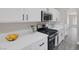 Close-up of the kitchen showcasing quartz countertops and stainless steel gas range at 5213 Giallo Vista Ct, North Las Vegas, NV 89031