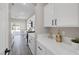 Well-lit kitchen features white cabinets, sleek countertops, and modern stainless steel appliances at 5213 Giallo Vista Ct, North Las Vegas, NV 89031