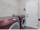 Well-equipped laundry room with side-by-side washer and dryer and white wire shelving at 5213 Giallo Vista Ct, North Las Vegas, NV 89031