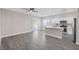 Bright, open-concept area with wood-look flooring, leading to the kitchen and outdoor access at 5213 Giallo Vista Ct, North Las Vegas, NV 89031