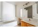 Bright bathroom featuring a large soaking tub, a spacious countertop, and a well-lit vanity area at 5655 E Sahara Ave # 1037, Las Vegas, NV 89142