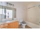 Bathroom featuring wood cabinets, a bath/shower combination, and a large mirror at 5655 E Sahara Ave # 1037, Las Vegas, NV 89142