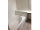 Bright bathroom features a white bathtub and ledge at 5655 E Sahara Ave # 1037, Las Vegas, NV 89142