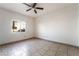 Spacious bedroom with a ceiling fan, neutral walls, and large window at 5655 E Sahara Ave # 1037, Las Vegas, NV 89142