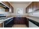 Efficient kitchen area with wood cabinets, updated appliances, and a window view at 5655 E Sahara Ave # 1037, Las Vegas, NV 89142