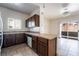 Functional kitchen with dark wood cabinets, a breakfast bar, and a view to the living room at 5655 E Sahara Ave # 1037, Las Vegas, NV 89142