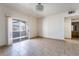 Spacious living room with tiled floors, chandelier, and sliding door to the outside at 5655 E Sahara Ave # 1037, Las Vegas, NV 89142