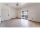 Bright living room featuring tile floors, a sliding glass door, and ample natural light at 5655 E Sahara Ave # 1037, Las Vegas, NV 89142