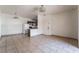 Open-concept living room with neutral tile floors and a view into the kitchen at 5655 E Sahara Ave # 1037, Las Vegas, NV 89142