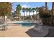 Community pool and spa surrounded by palm trees and lounge chairs at 5655 E Sahara Ave # 1037, Las Vegas, NV 89142