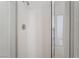 Shower stall featuring a glass door, white tile, and updated fixtures at 5655 E Sahara Ave # 1037, Las Vegas, NV 89142