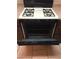 Close-up of a white gas stove with black oven in the kitchen at 5655 E Sahara Ave # 1037, Las Vegas, NV 89142