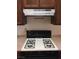 Close up of the gas stove top and stainless vent over it at 5655 E Sahara Ave # 1037, Las Vegas, NV 89142