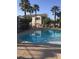 A community swimming pool with a staircase and palm trees at 5655 E Sahara Ave # 1037, Las Vegas, NV 89142
