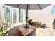 Charming back patio with a stylish table, chairs, and lush potted plants at 6009 La Coste St, North Las Vegas, NV 89081