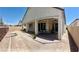 A backyard featuring a covered patio with ceiling fans, gravel ground and a defined rock border at 6009 La Coste St, North Las Vegas, NV 89081