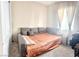 Cozy bedroom featuring a gray sofa bed with a window and natural light at 6009 La Coste St, North Las Vegas, NV 89081