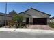 Charming single-story home with a well-maintained front yard and a brick-paved driveway and front walkway at 6009 La Coste St, North Las Vegas, NV 89081