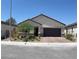 Charming single-story home with a well-maintained front yard and a brick-paved driveway and front walkway at 6009 La Coste St, North Las Vegas, NV 89081