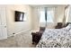 Spacious main bedroom with mounted TV, large window, and comfortable furnishings at 6009 La Coste St, North Las Vegas, NV 89081
