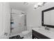 Bright bathroom featuring tiled shower, modern fixtures, and a sleek vanity at 6017 Natures Dr, Las Vegas, NV 89122