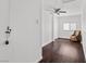 Bedroom featuring wood-look floors, a ceiling fan, and minimalist décor, enhanced by natural light at 6017 Natures Dr, Las Vegas, NV 89122