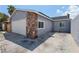 Single Gathering home with stone accent, attached garage, and concrete driveway at 6017 Natures Dr, Las Vegas, NV 89122