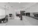 Bright kitchen with stylish light fixtures, dining area, and stainless steel appliances, flowing into the living space at 6017 Natures Dr, Las Vegas, NV 89122