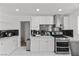 Modern kitchen featuring stainless steel appliances, sleek cabinets, and mosaic backsplash at 6017 Natures Dr, Las Vegas, NV 89122