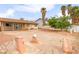 Backyard with patio and desert landscaping featuring three large rock decorations, providing ample space for outdoor activities at 604 N Torrey Pines Dr, Las Vegas, NV 89107