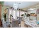 Bright dining area with a glass-top table, elegant chandelier, and backyard access at 604 N Torrey Pines Dr, Las Vegas, NV 89107